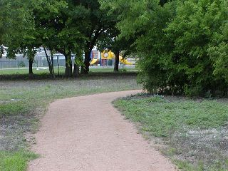 View along the District's hike and bike trail system with playground in background.